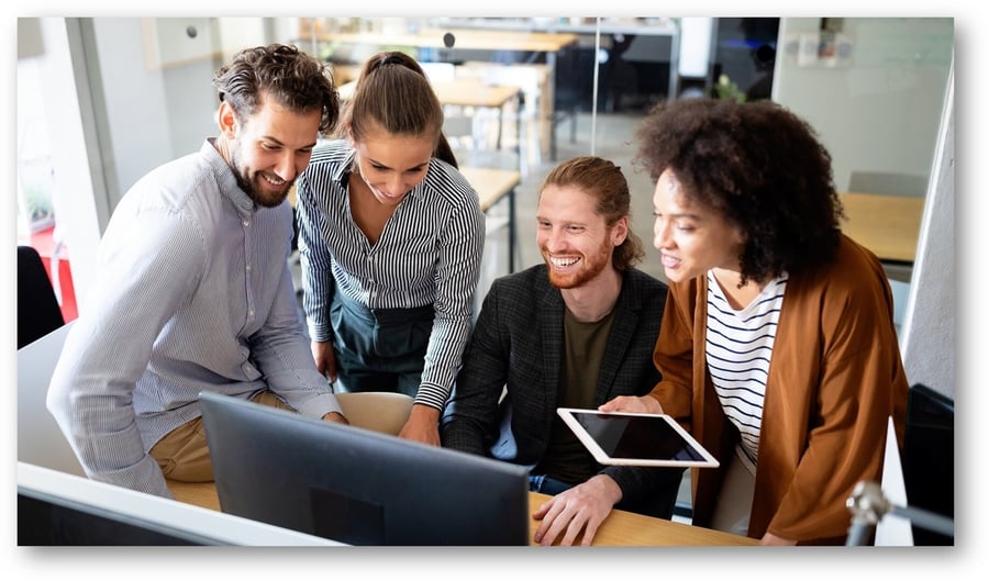 Happy group of people working together infront of computer (Large)
