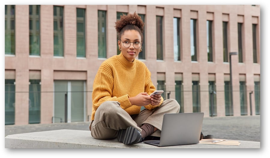 pretty-female-student-uses-smartphone-and-laptop 16.9 (Large) (Large)